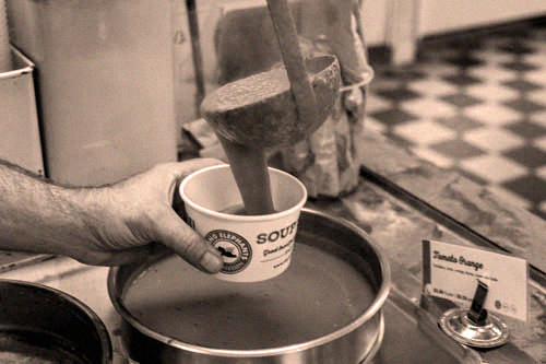Elephants Delicatessen soup being ladled from a pot into a to go container