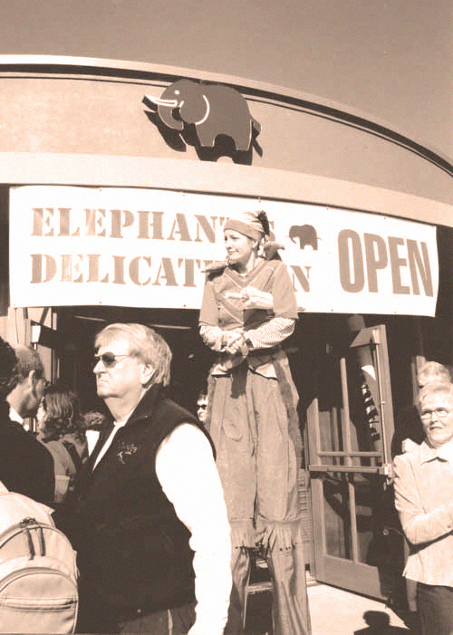 Elephants Delicatessen 2004 store opening with elf on stilts
