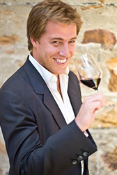 man drinking wine and smiling