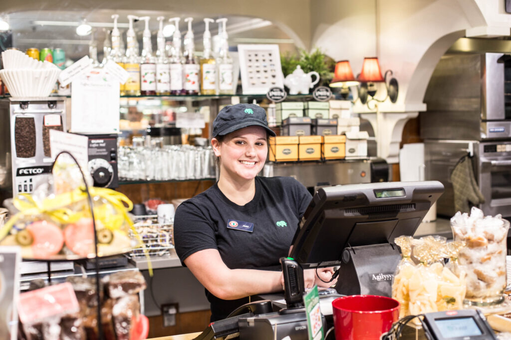 employee behind register at Elephants Delicatessen PDX airport