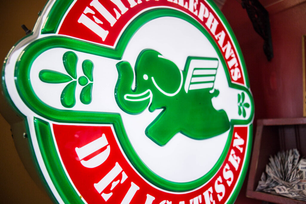 neon sign with Elephants Delicatessen logo at Kruse Way