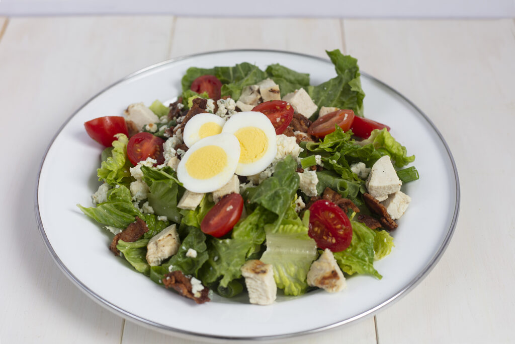 Cobb Salad witting on a white table