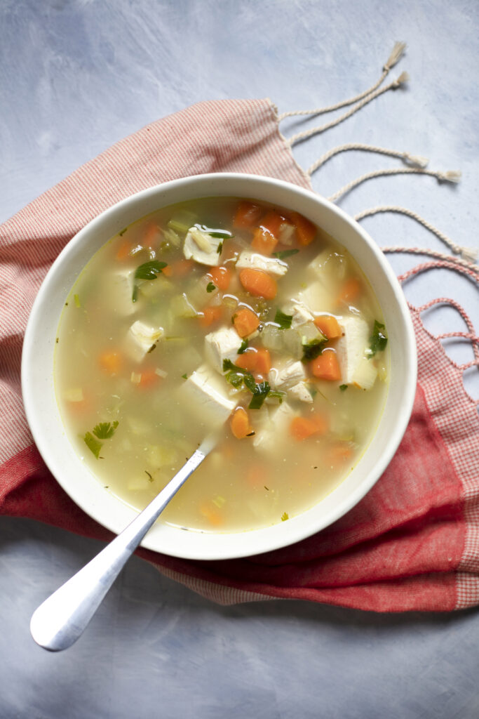 Elephants cure soup on a table with a red towel