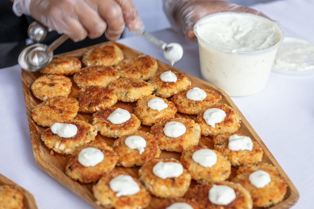Plate of Dungeness crab cakes with dollops of tarter sauce